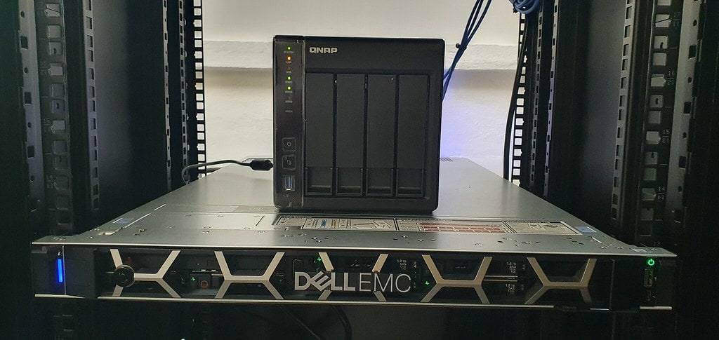 QNAP network storage unit sitting on a Dell EMC rack server.